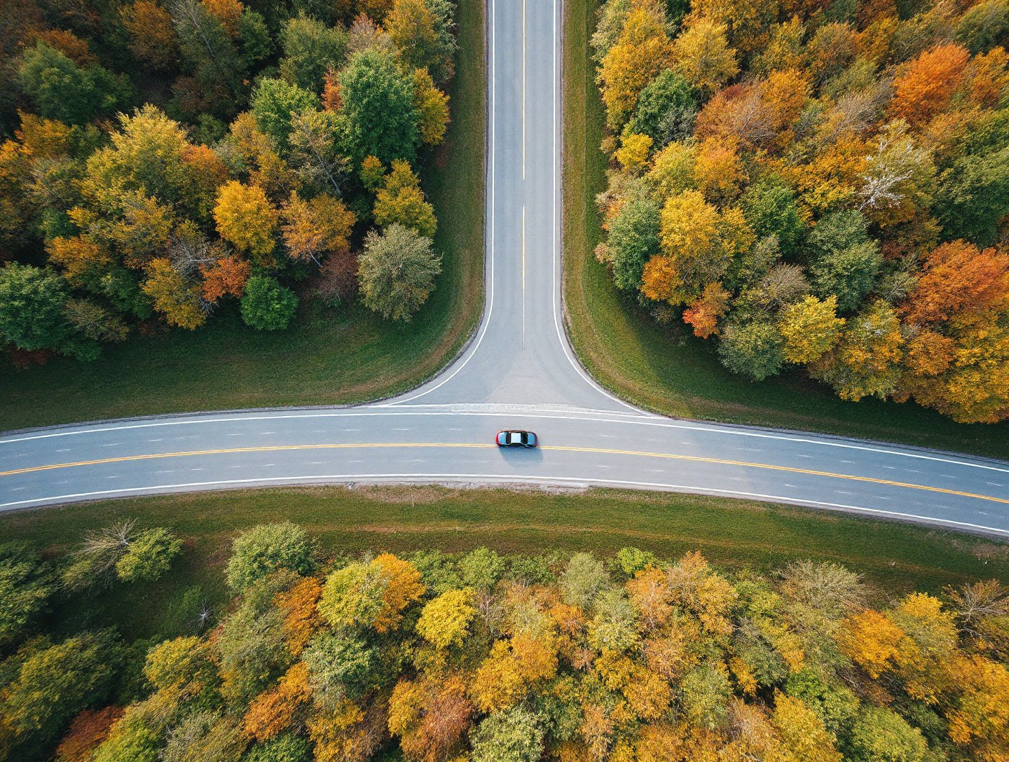 Car on a highway through upstate New York hills